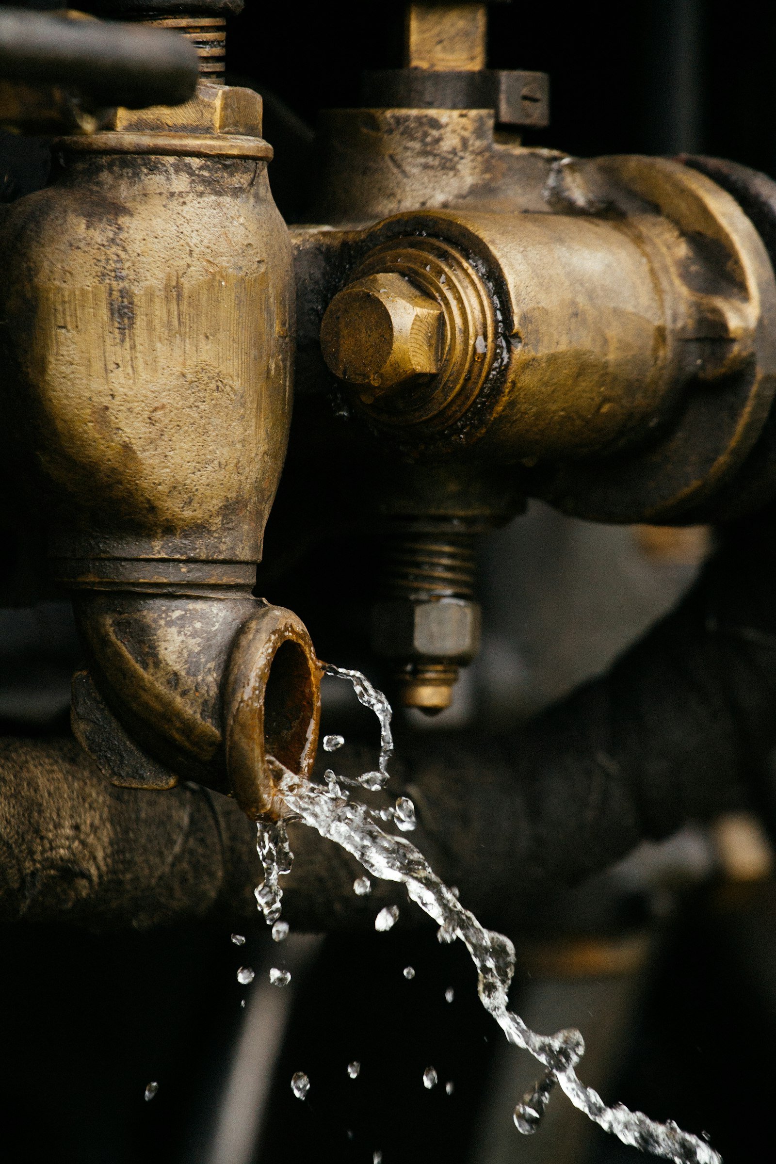 Water dripping from an old brass pipe fitting